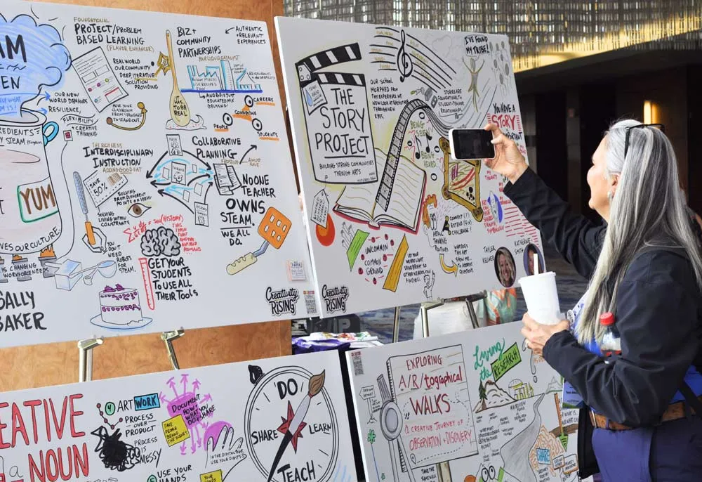 Event attendee admiring Matt Orley's graphic recording at a a