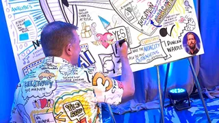 Matt Orley illustrating live on a large graphic recording board at a conference